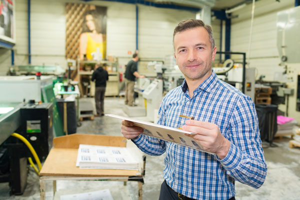 man-holding-clipboard-in-warehouse